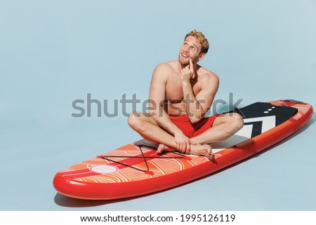 Similar – Image, Stock Photo Pensive man with paddle board before surfing