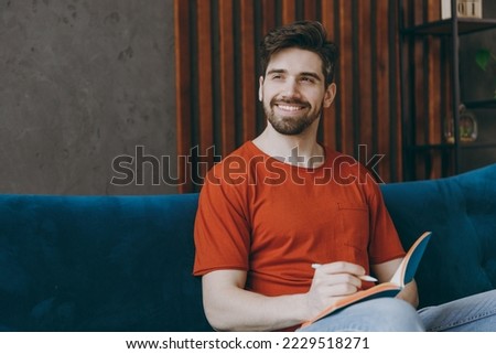 Similar – Image, Stock Photo Relaxed man reading notes in notebook