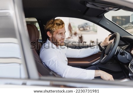 Similar – Image, Stock Photo Man sits in car and looks seriously out the window