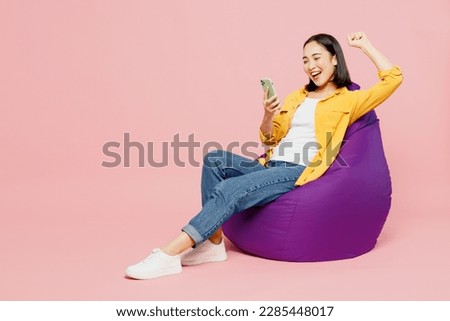 Similar – Image, Stock Photo young woman wearing yellow raincoat standing next to hammock with her jack russell dog. autumn season. camping concept