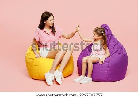 Similar – Image, Stock Photo Mother and daughter sit in the Lotus position in the garden. The family practices yoga outdoors. Back view, space for text