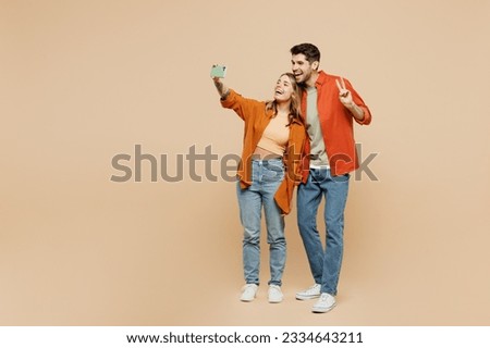 Similar – Image, Stock Photo two girls in a park take cell phone selfies while hugging. They are both very pretty and smile happily. One is wearing a pink sweater and the other is wearing a studded jacket