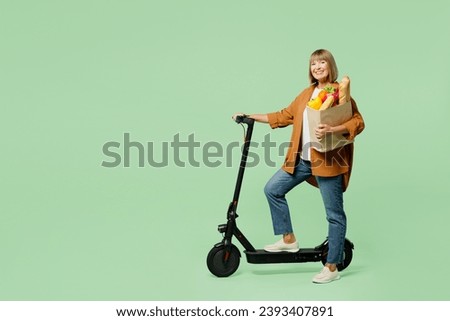 Similar – Image, Stock Photo Electric scooter with shopping bags and woman in background.