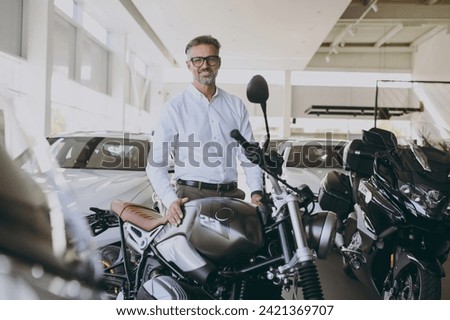 Similar – Image, Stock Photo Man in motorcycle looking at camera