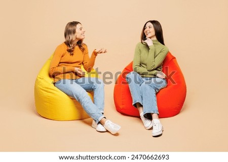 Similar – Image, Stock Photo two girls in a park take mobile selfies. They are both very pretty and smile happily. One is wearing a pink sweater and the other is wearing a studded jacket