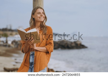 Similar – Image, Stock Photo A happy young woman is sitting in a lotus position and doing yoga on the beach at sunset. The concept of a healthy active lifestyle