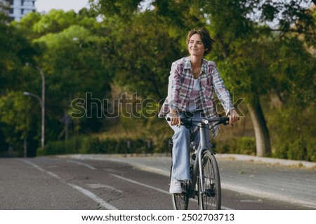 Similar – Image, Stock Photo Woman with bicycle walking in park