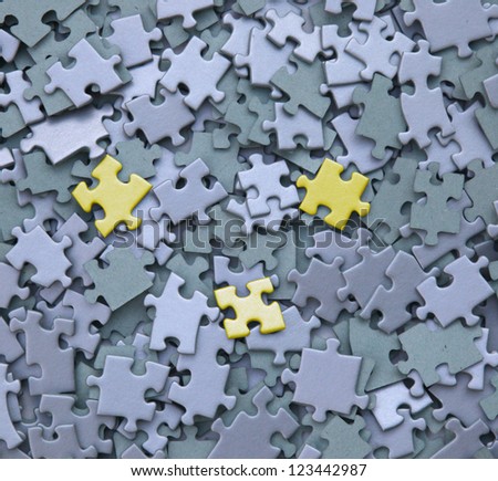 jigsaw puzzle with three yellow tiles