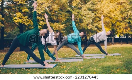 Similar – Image, Stock Photo Slender barefooted woman stretching body in bound angle pose in contemporary studio