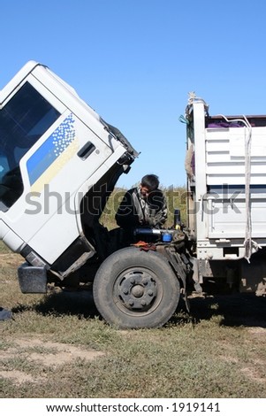 Man repairing a broken truck