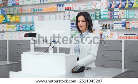 Similar – Image, Stock Photo Concentrated female cashier in face mask working with cash till