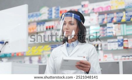 Similar – Image, Stock Photo Concentrated female cashier in face mask working with cash till