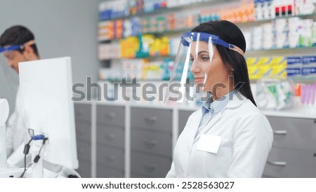 Similar – Image, Stock Photo Concentrated female cashier in face mask working with cash till