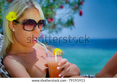 The girl with a cocktail near the sea