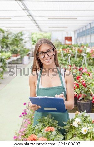pretty young flower seller checks his folder
