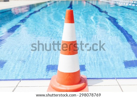 swimming pool repair - safety cone on edge