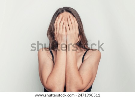 Similar – Image, Stock Photo Woman covering face with hands in black and White