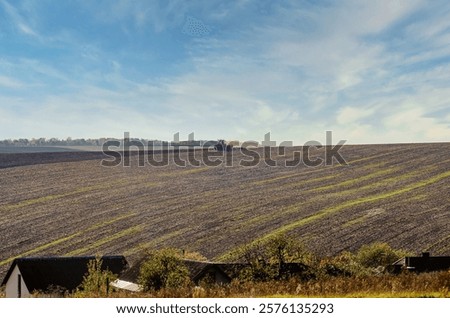 Similar – Foto Bild Ländliches Feld unter bewölktem Himmel mit Sonnenstrahlen