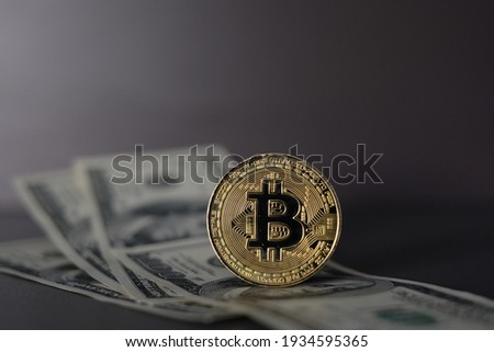 US Dollar and Digital money Bitcoin coin Put together. Concept of digital money is becoming a competitor in major currencies such as the dollar.
