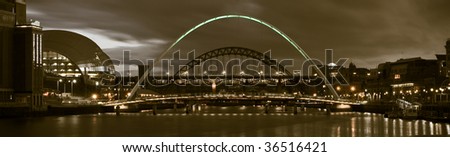 De saturated and toned Panoramic image of Newcastle Quayside and Millennium Bridge at Dusk