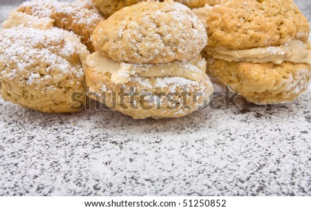 Coffee Kiss Biscuits with dusting of icing sugar and butter cream filling.