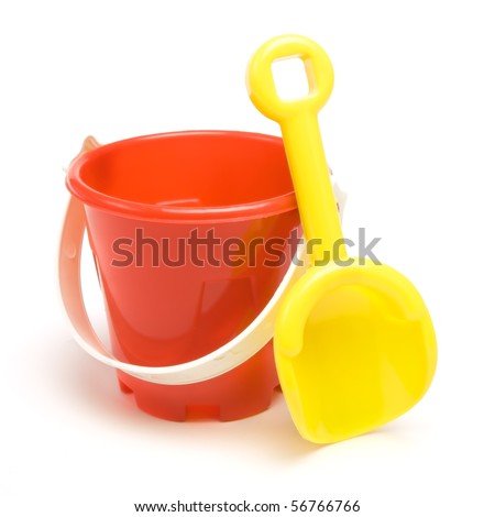 Kids red bucket and yellow spade summer holiday concept isolated against white background.