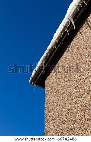 Cold snap home maintenance concept of frozen gutters.