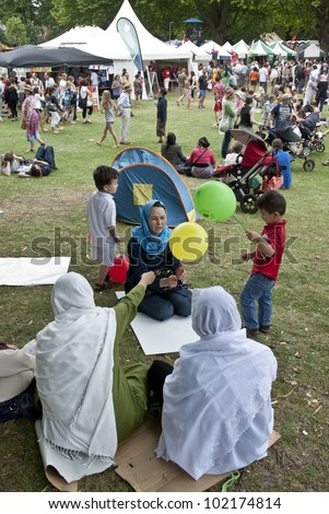 EXETER - JUNE 4: Festival goers at the Exeter Respect Festival sit in the park and enjoy the day on June 4, 2011 in Exeter, UK.
