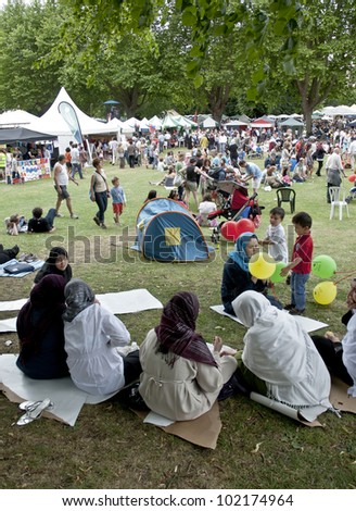 EXETER - JUNE 4: Festival goers at the Exeter Respect Festival sit in the park and enjoy the day  on June 4, 2011 in Exeter, UK.