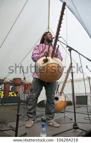 EXETER - JUNE 3: Modou N'Diaye plays the Kora live on the Global Community Stage at the Exeter Respect Festival on June 3, 2012 in Exeter, UK