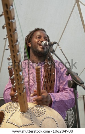 EXETER - JUNE 3: Modou N\'Diaye plays the Kora live on the Global Community Stage at the Exeter Respect Festival on June 3, 2012 in Exeter, UK