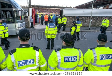 EXETER, ENGLAND - FEBRUARY 21, 2015: Devon and Cornwall Police prepare for Plymouth Argyle football fans to leave during the League 2 football match between Exeter City FC and Plymouth Argyle FC