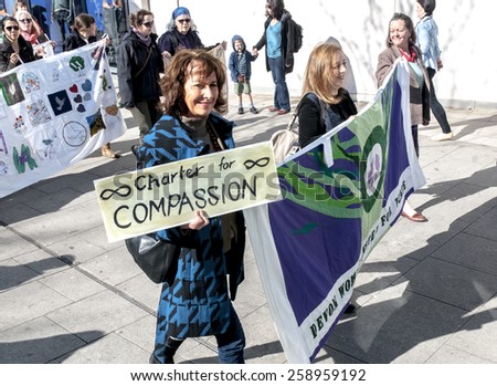 EXETER, ENGLAND - MARCH 7, 2015: Devon United Women walk through Exeter during the Walk for Peace through the city of Exeter to celebrate International Women\'s Day.
