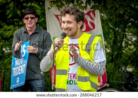 EXETER, ENGLAND - JUNE 13, 2015: Joe Levy from University of Exeter Green Party, speaking at the Devon \'End Austerity NOW!\' Rally in Northernhay Gardens, Exeter on June13th, 2015 in Exeter, UK