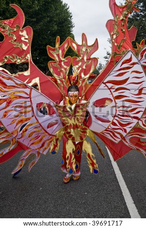 NOTTING HILL, LONDON - AUG 30: Man in a fire costume from the  Flamboyan Carnival Mas Camp float the Notting Hill carnival on August 30, 2009 in London, UK.