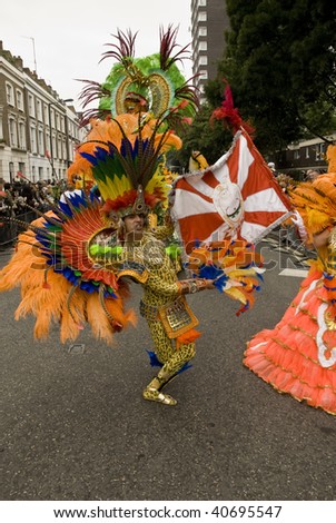 LONDON - AUGUST 25: A dancer with a flag from the Paraiso School of Samba float during the Notting Hill Carnival on August 25, 2008 in London, England.