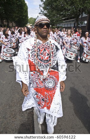 NOTTING HILL, LONDON - AUG 31: The band leader from Batala Banda de Percussao leading the band throught the streets at the Notting Hill Carnival August 30, 2010 in Notting Hill, London, England