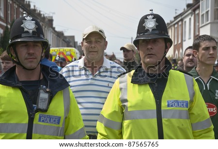 EXETER - APRIL 30:  Devon and Cornwall Police escort football fans to prevent football violence at the League 1 match between Exeter City FC and Plymouth Argyle FC on April 30, 2011 in Exeter