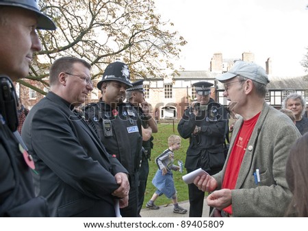 EXETER - NOVEMBER 12: Police film occupy Exeter organiser Ghee Bowman talking with acting dean Carl Turner at the occupy Exeter site of Exeter Cathedral on November 12, 2011 in Exeter City Centre