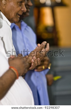TORONTO - JUNE 19: The hands of Hindu devotees as they pray during the chariot festival at  Richmond Hill Temple on June 19, 2009 in Toronto, Canada