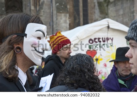 EXETER - JANUARY 28: An Occupy Exeter activist wearing a Guy Fawkes mask before the movements direct action against the Exeter branches of Topshop, HSBC & Vodaphone   on January 28, 2012 in Exeter, UK