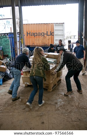 EXETER - MARCH 9: Volunteers from BookCycle loads a box into the container that is taking donated book to Ghana on March 9,  2012 in Exeter, UK