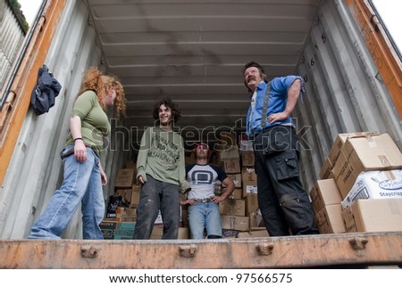 EXETER - MARCH 9: Volunteers from BookCycle stack boxes inside the container that is taking donated books to Ghana on March 9,  2012 in Exeter.