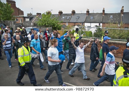 EXETER - APRIL 30: Devon and Cornwall Police escort football fans to prevent football violence at the League 1 match between Exeter City FC and Plymouth Argyle FC on April 30, 2011 in Exeter, UK.
