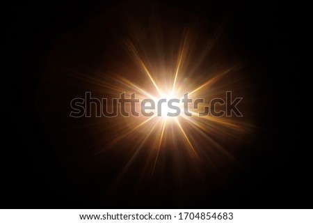 Easy to add lens flare effects for overlay designs or screen blending mode to make high-quality images. Abstract sun burst, digital flare, iridescent glare over black background. 商業照片 © 