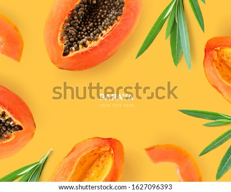 Creative layout made of papaya and leaves. Flat lay. Food concept. Papaya on yellow background. 商業照片 © 