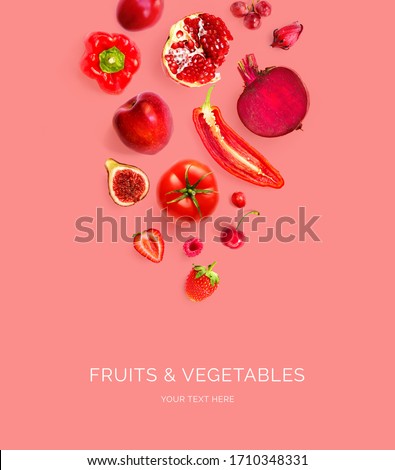 Creative layout made of red apple, red pepper, red grape, beetroot, pomegranate, strawberry, raspberry, cherry, chilli, tomato  on the red background. Flat lay. Macro  concept.