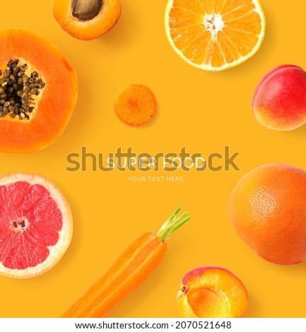 Creative layout made of  papaya, orange, carrot, grapefruit and apricot on the orange background. Flat lay. Food concept. Macro  concept.