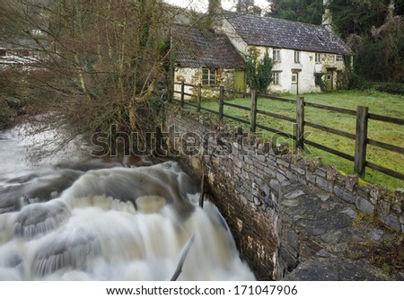 River Angidy in Spate, with old cottages, Tintern