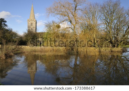 Ashleworth Church reflected in flood water on the banks of the River Severn